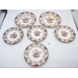 Six Wedgwood 'Camellia' plates in pink and gold, four at 8" diameter and two at 9 1/2" diameter.