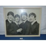 A signed photograph of The Beatles, 21'' x 16 3/4''.