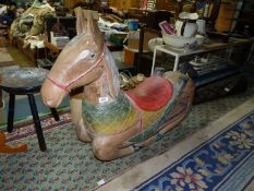 A large, heavy Rocking Horse, with colourful detail to saddle and reins, 44" long x 30" tall.
