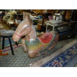 A large, heavy Rocking Horse, with colourful detail to saddle and reins, 44" long x 30" tall.