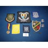 A small quantity of cloth and metal badges, a medal, Rupert stick pin in the form of a policeman.