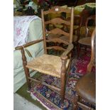 An Elm and Ashwood ladderback Armchair having a woven seagrass seat.