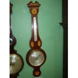 A mercury Banjo barometer having a marquetry shell with flower detail, crack to glass, 39" long.