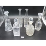 A quantity of Decanters with stoppers, some cut glass and two etched ones.