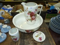 A Tams Ware china bedroom set having pink rose design to include; jug, bowl, vase and soap dish.