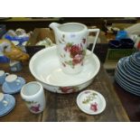 A Tams Ware china bedroom set having pink rose design to include; jug, bowl, vase and soap dish.