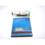 A vintage model of a ship in a bottle, titled Onyx,