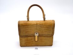 A mid 20th century cream coloured crocodile skin handbag made in England by Loewe;