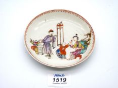 A mid-18th century Chinese porcelain saucer painted with an interior scene.