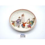 A mid-18th century Chinese porcelain saucer painted with an interior scene.