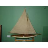 A Pond Yacht in green with two sails, 45'' long x 45'' high.