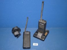 Two Motorola Radius GP300 walkie talkies with battery charger.