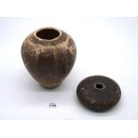 A rare Khmer pottery vase, 12th century glazed in brown with ribbed decoration, the top reduced,