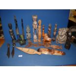 A quantity of ethnic wooden carved figures, letter openers, etc.