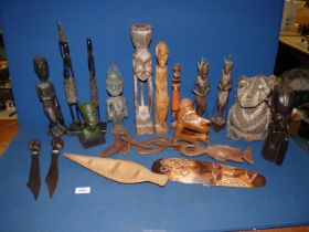 A quantity of ethnic wooden carved figures, letter openers, etc.
