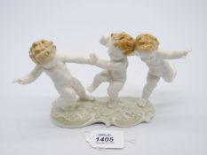 A 'Hutschenreuther' figure of three Cherubs.