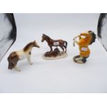 Three china horse ornaments including mare and foal.