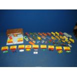 A box of play worn Matchbox toys together with a toy garage and other boxed cars.