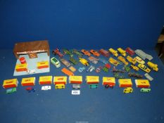 A box of play worn Matchbox toys together with a toy garage and other boxed cars.