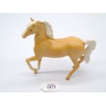 A Royal Doulton Palomino Arab, gloss finish, boxed, 7'' long x 7'' tall.