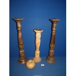 Three tall candlesticks; two dark wood and one lightwood, 24" tall.