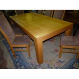 A heavy specially commissioned light Pippy Oak rectangular Dining Table standing on square legs,