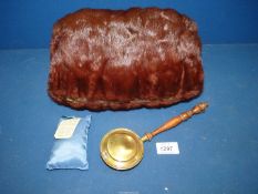 A Mink hand muff with internal pocket for miniature brass warming pan with turned handle.