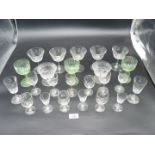 A quantity of fine glasses some with and engraved initial 'E' , three green glasses etc.