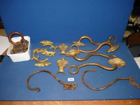 A quantity of ornate Regency style curtain brackets and tie backs and a quantity of curtain rings