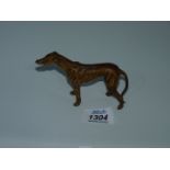 A painted cast metal figure of a greyhound, 4 1/4" x 3" high.