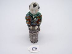 A Japanese porcelain figure of a Gent with a basket, 7 1/2" tall.