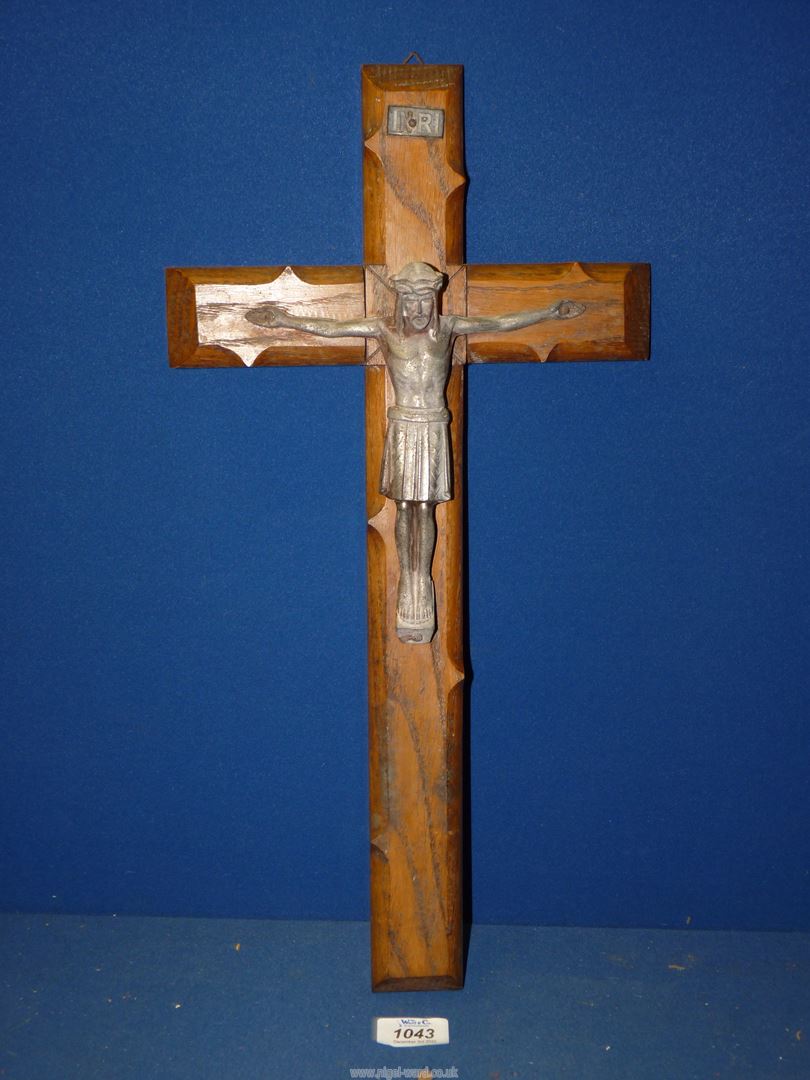 A hand carved wooden Crucifix with metal figure of Christ, 19'' long.