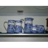 A trio of Italian Spode design jugs, 8 1/4", 6 3/4" and 5 3/4" plus two matching milk/cream jugs,