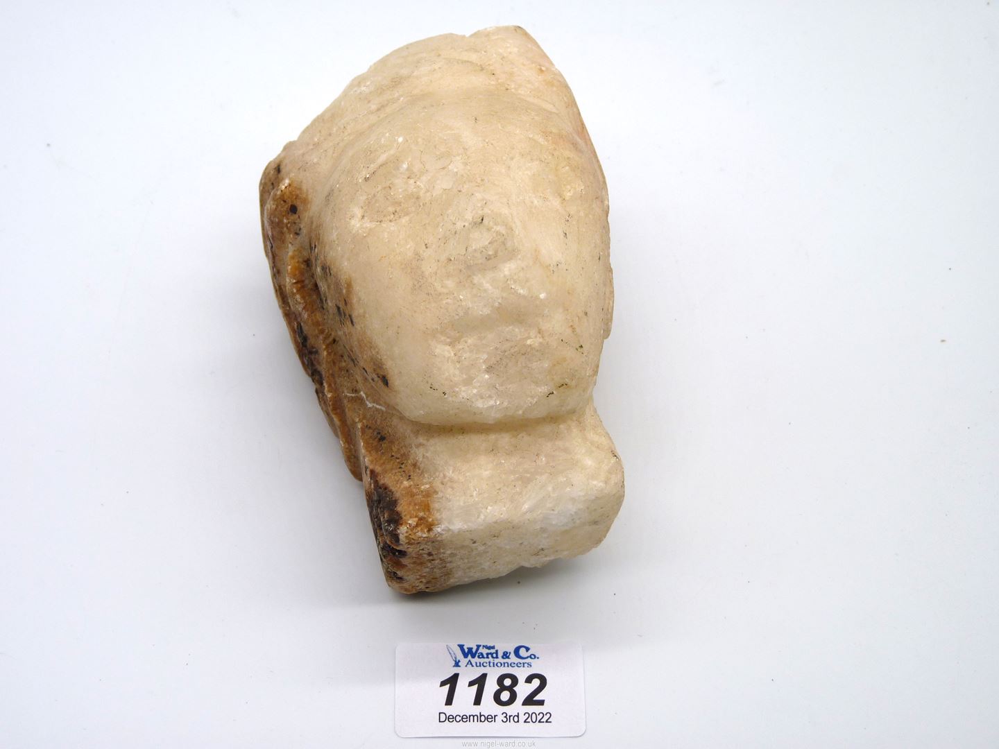 An early fragmentary alabaster head of a woman wearing a headdress of Renaissance style;