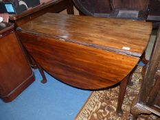 An early 19th century Mahogany swing leg dropleaf Dining Table standing on canted cabriole legs,