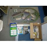 An 'N' gauge model railway layout on thick base ( 37 1/2'' x 23 3/4'') with a box of buildings,