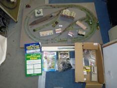 An 'N' gauge model railway layout on thick base ( 37 1/2'' x 23 3/4'') with a box of buildings,