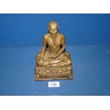 A bronze effect Buddha figure of the Medicine Man, 7 1/2" tall.
