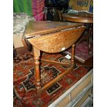 An unusual triangular Oak occasional Table reminiscent of a cricket table having three turned legs