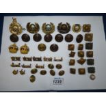 A quantity of Royal Marines badges, buttons, shoulder titles and officers crowns and pips,