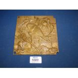 A small well cast bronze plaque depicting storks in a wetland landscape (two storks together