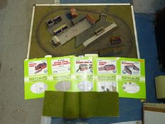 An 'N' gauge model railway layout on thin board (37 1/2'' x 23 3/4'') and packs of building sets
