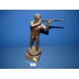 A composite figure of a man with a shotgun, on plinth base, (possibly a shooting trophy),