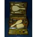 A ladies Crocodile skin Vanity Case with silver topped glass bottles, hallmarks for London 1899,