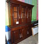 A dark Mahogany triple Bookcase on Cupboard, the upper portion with three arched glazed doors,