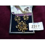 An 18ct gold and diamond and sapphire brooch and screw on earrings set in abstract design, 15.