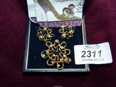 An 18ct gold and diamond and sapphire brooch and screw on earrings set in abstract design, 15.
