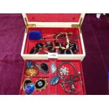 A quantity of gold and black coloured necklaces, bangles, brooches, pendants etc,