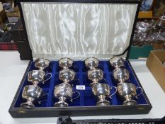 A cased set of twelve silver plated and gilt lined Punch Cups.