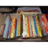 A box of children's books including Yogi Bear annuals, The Flintstones,